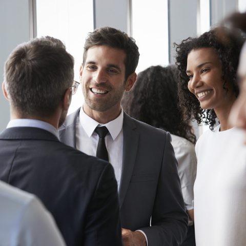 Group Of Businesspeople Having Informal Office Meeting Group Of Businesspeople Having Informal Office Meeting
