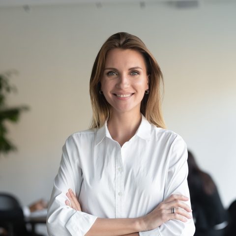 Smiling female professional manager standing arms crossed looking at camera Smiling beautiful female professional manager standing with arms crossed looking at camera, happy confident business woman corporate leader boss ceo posing in office, headshot close up portrait